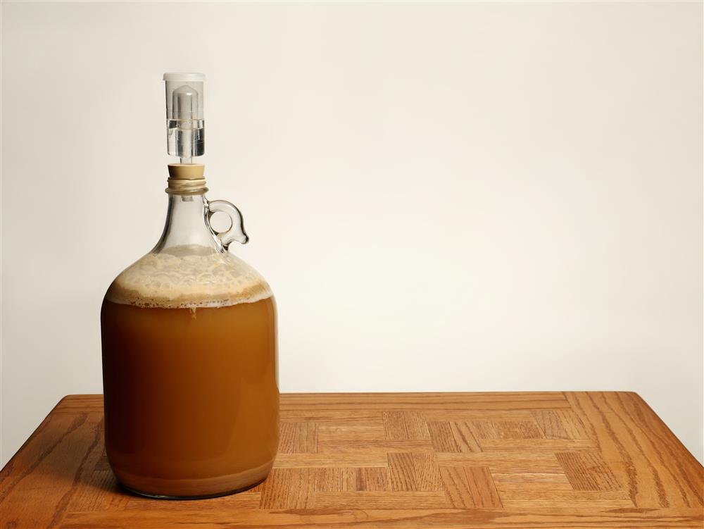Beer being brewed in a carboy, one of several home brewing containers that you can get from a packaging distributor.