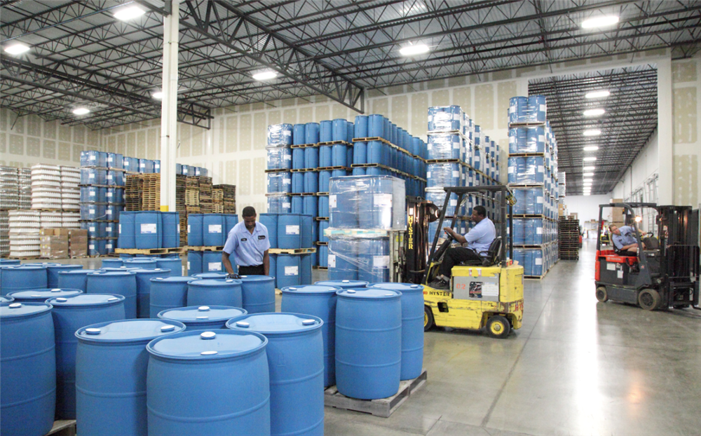 DOT inspector reviewing UN markings on hazmat packaging.