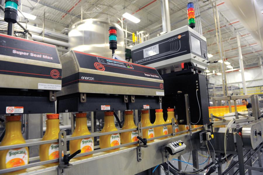 Plastic bottles with induction liners being sealed.