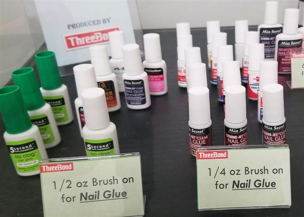 A selection of ThreeBond nail glue bottles with custom injection molded neck inserts.