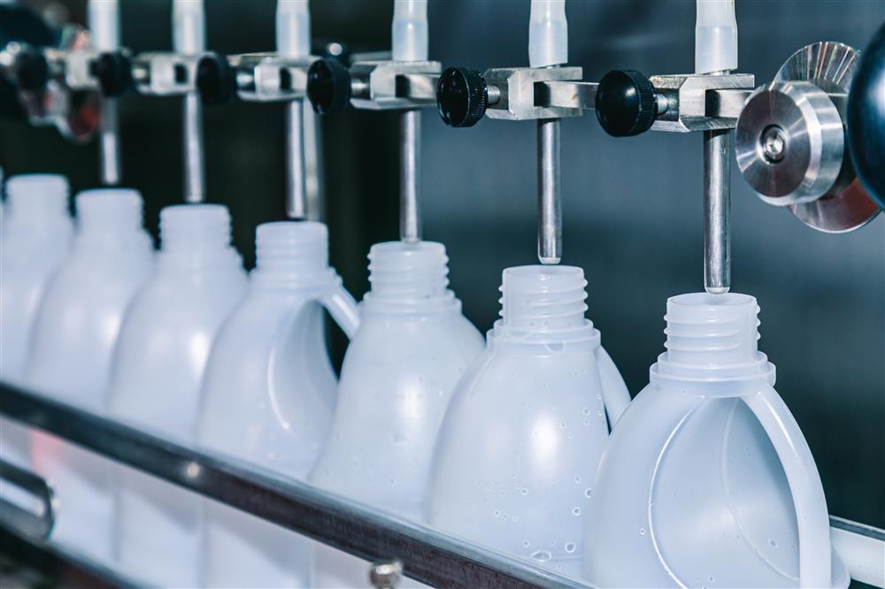 Plastic bottles being filled after passing compatibility testing.