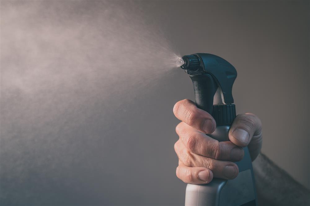A trigger spray bottle being used by a customer.